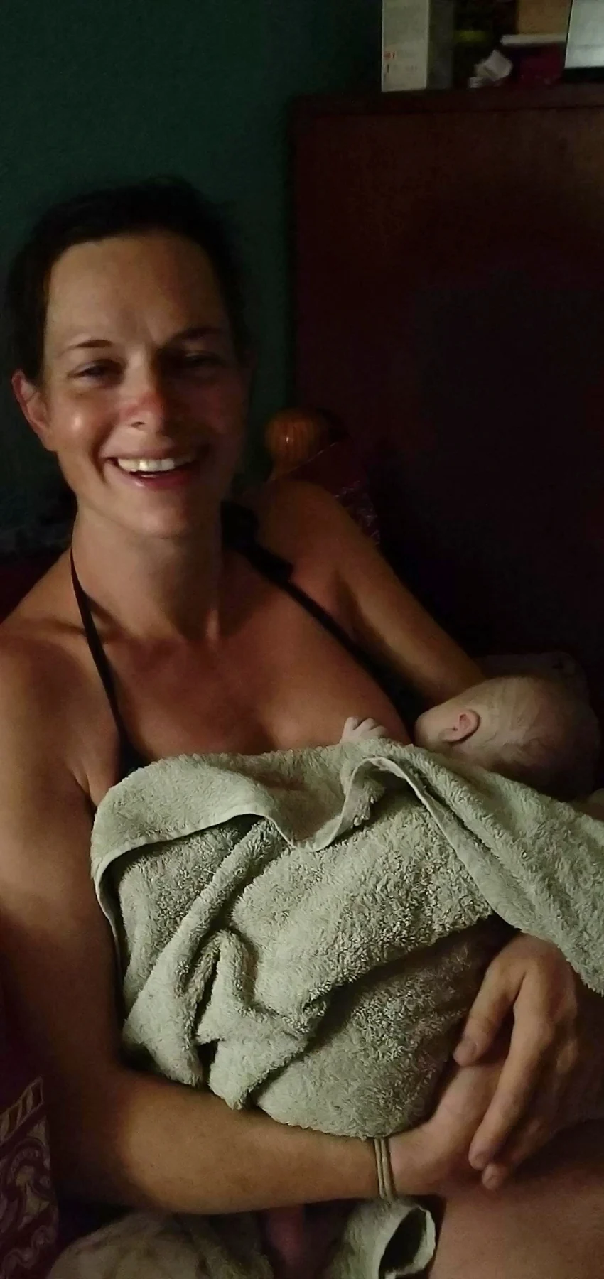 Ros smiling while holding newborn Wilfy
