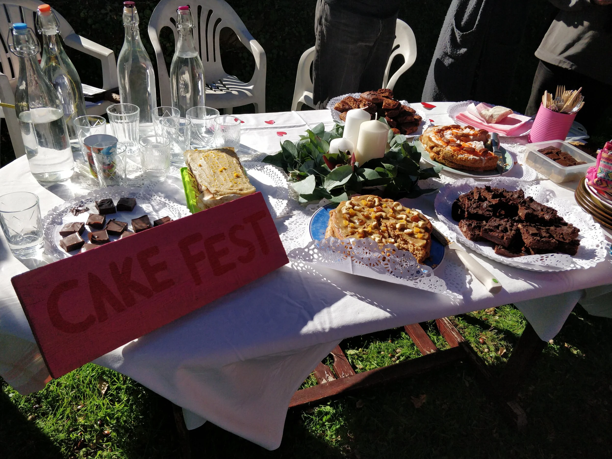 Homemade cakes arranged on a long outdoor table during Cake Fest in Portugal