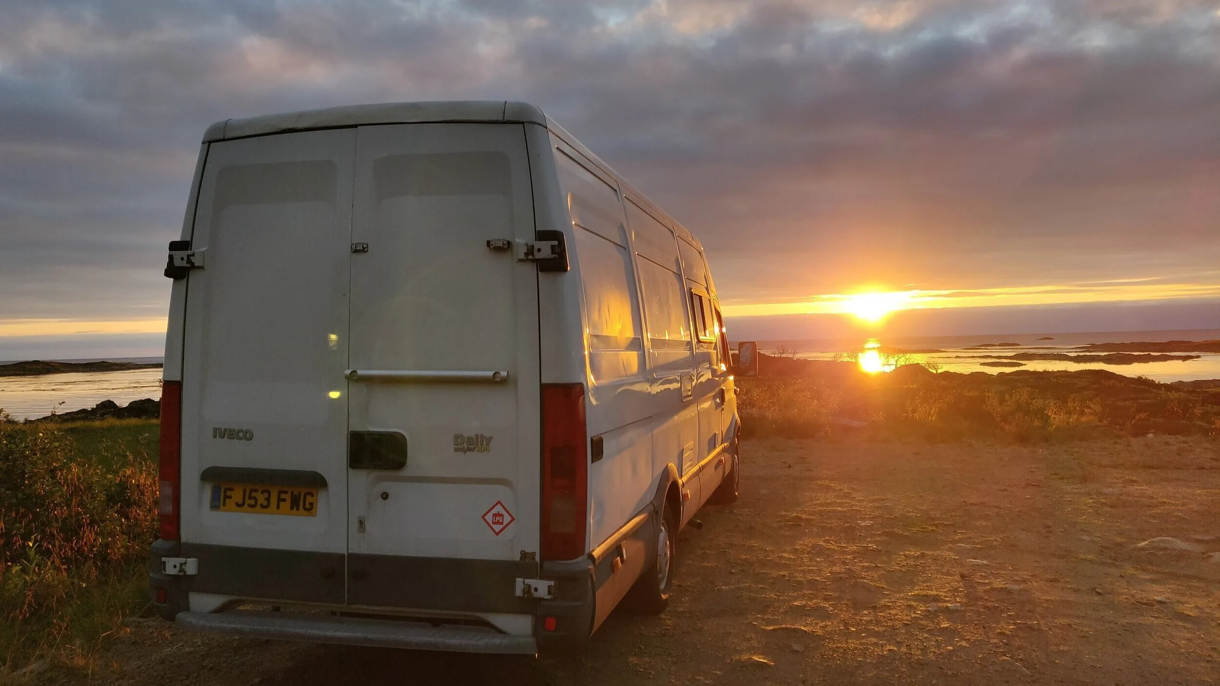 Ivor, the family's self-converted Iveco Daily campervan, parked beneath a sunset sky