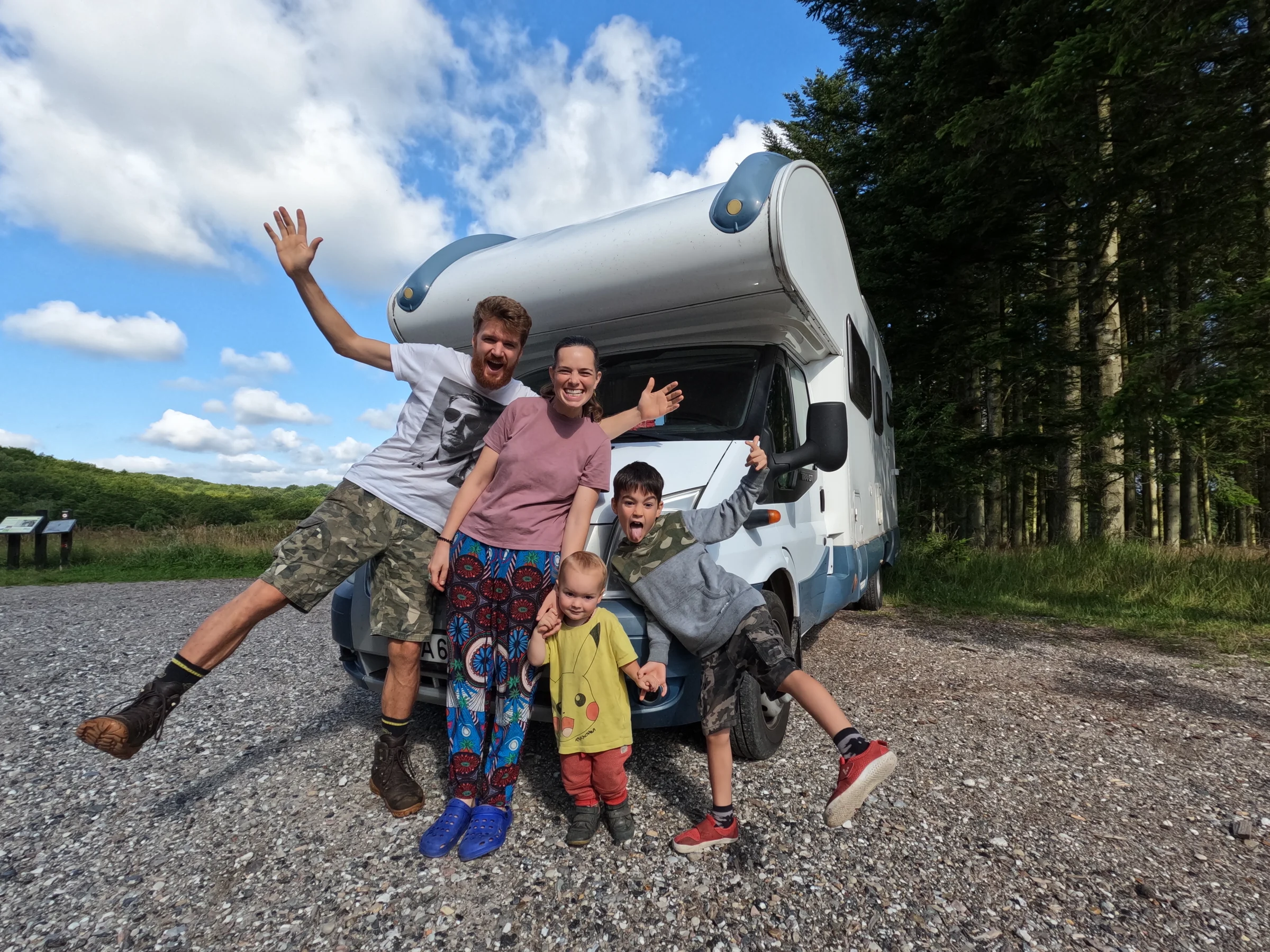 Tom, Ros, Lawrie and Wilfy celebrating beside their Ford Transit motorhome during a family road trip through Scandinavia