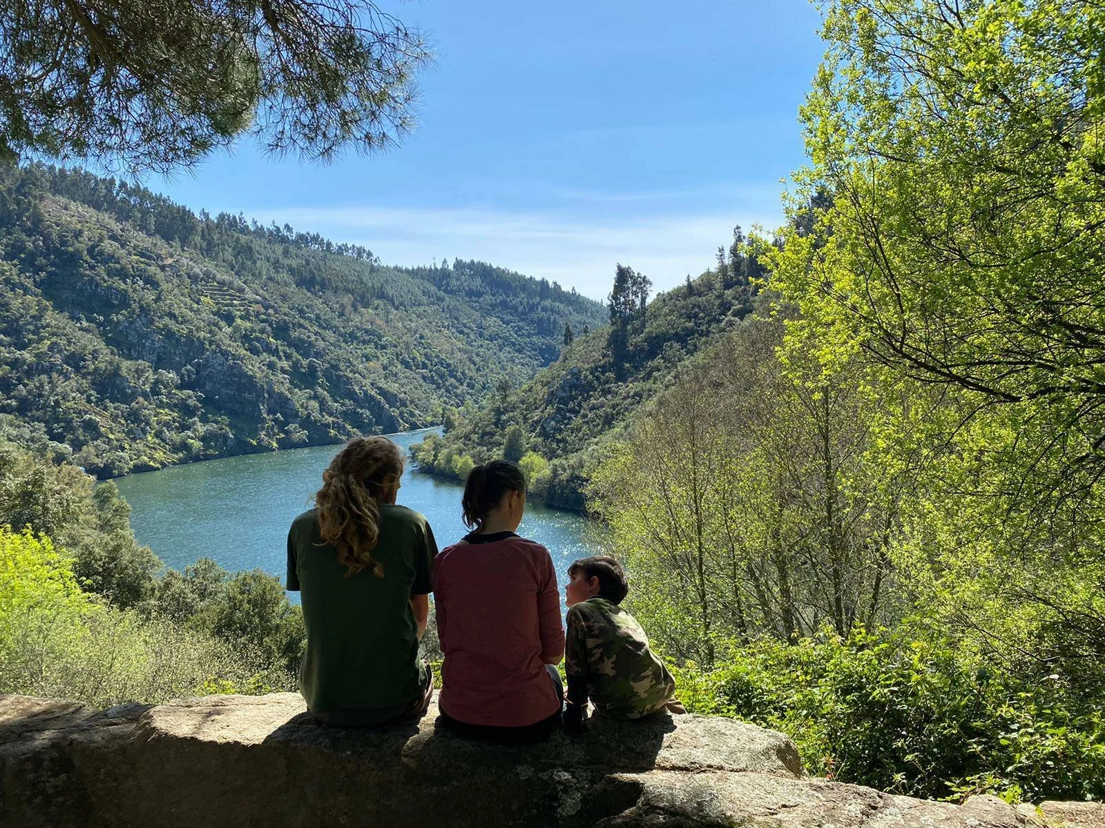 Tom, Ros, Lawrie and Wilfy sitting together beside a river in Portugal