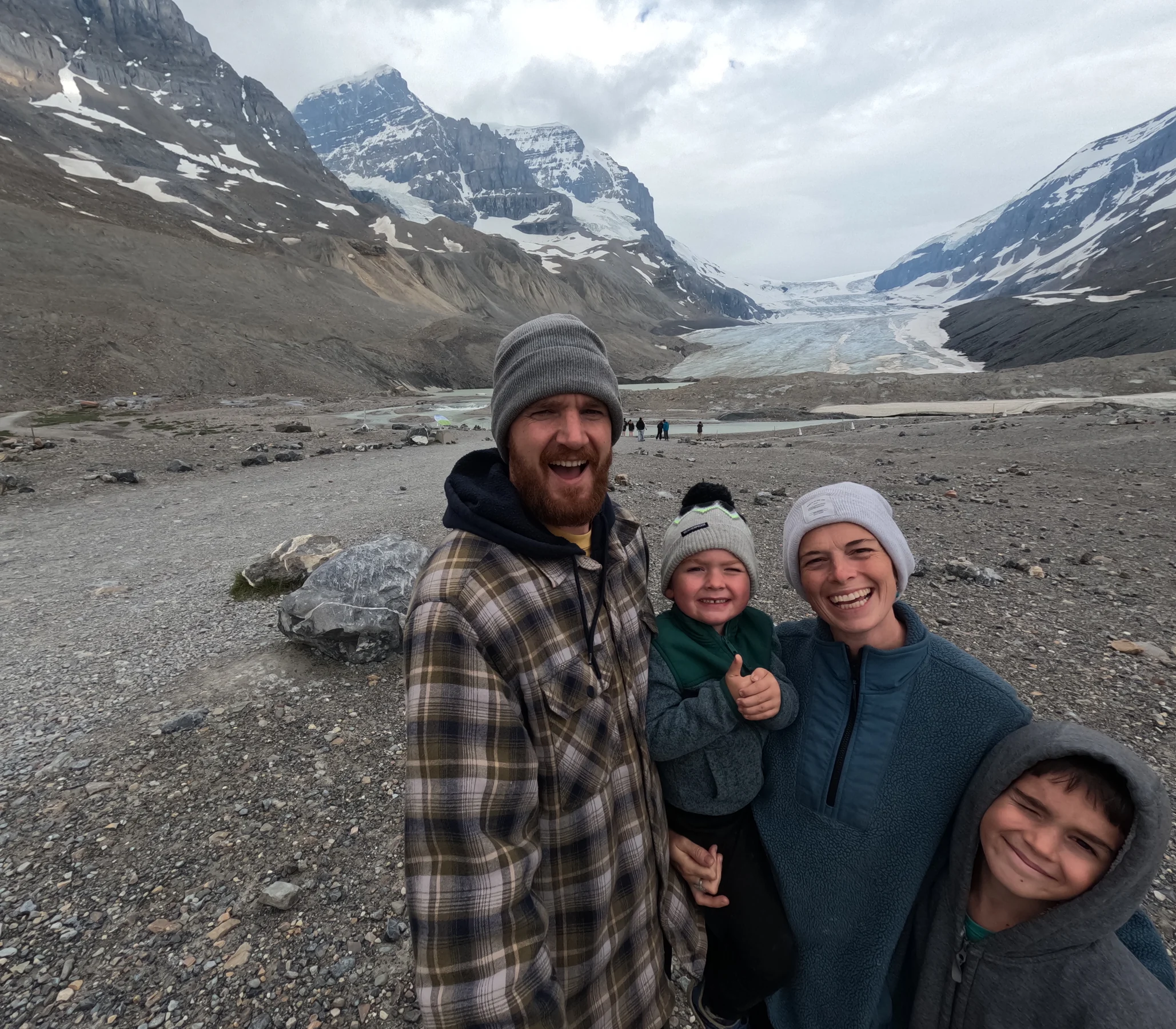 Tom, Ros, Lawrie and Wilfy standing together in front of a glacier in North America